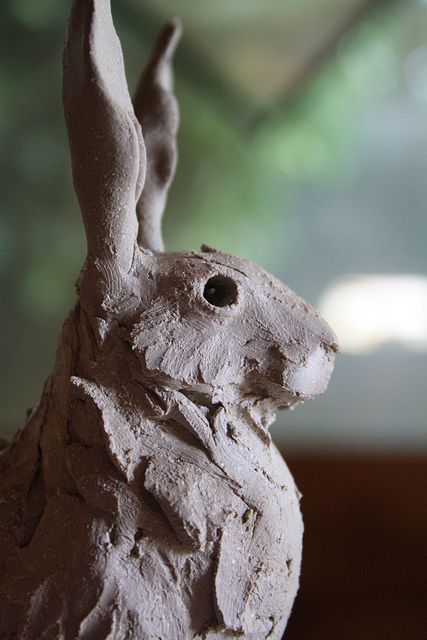 a clay rabbit sitting on top of a table