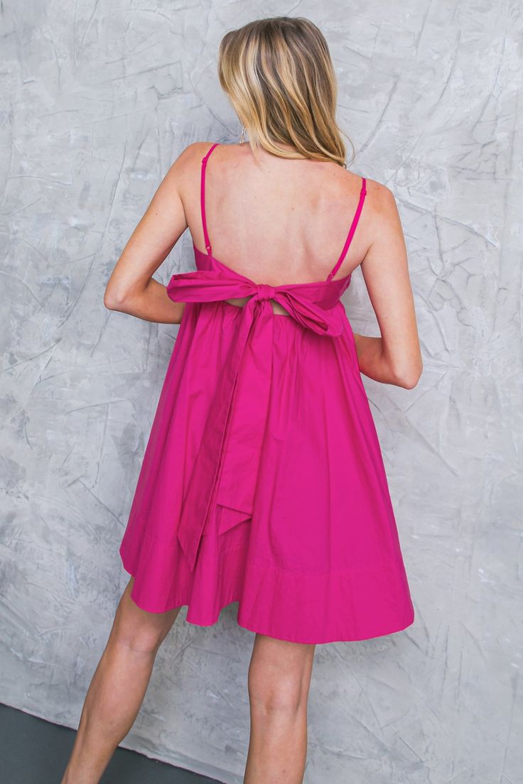 This GIVE IT A GUESS WOVEN MINI DRESS is the perfect pick for occasions. Its solid woven fabric and pleated bodice create an alluring silhouette, while its cami top and open back with tie detailing add to the femininity of the look. Effortlessly stylish, this mini dress is great for any event. Details Self : 100% Cotton Lining : 100% Polyester Size & Fit - Model is 5`8" And Wearing Size Small - Measurements Taken From Size Small - Approx. Length: 34.5" Feminine Mini Dress With Spaghetti Straps And Tie Back, Chic Backless Mini Dress With Bow Straps, Chic Bow Mini Dress For Daywear, Chic Mini Dress With Bow For Daywear, Daywear Tie-back Dresses, Chic Backless Mini Dress With Tie Straps, Spring Backless Mini Dress With Bow Tie Back, Chic Pink Mini Dress With Tie Straps, Chic Mini Dress With Adjustable Straps For Brunch