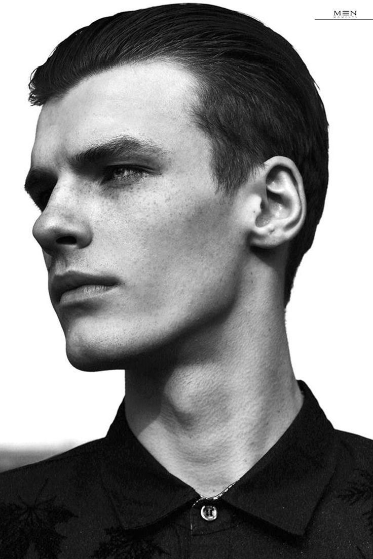 black and white photograph of a young man with short hair wearing a collared shirt