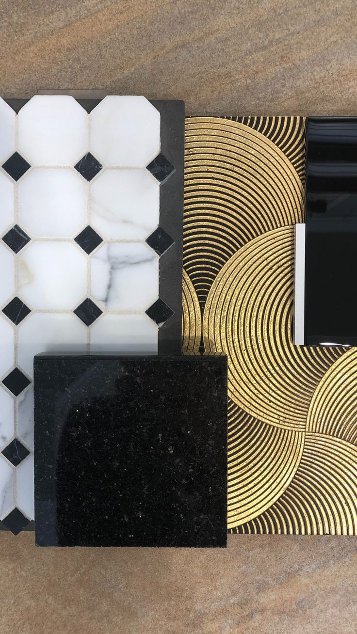 a cell phone sitting on top of a table next to a black and white tile