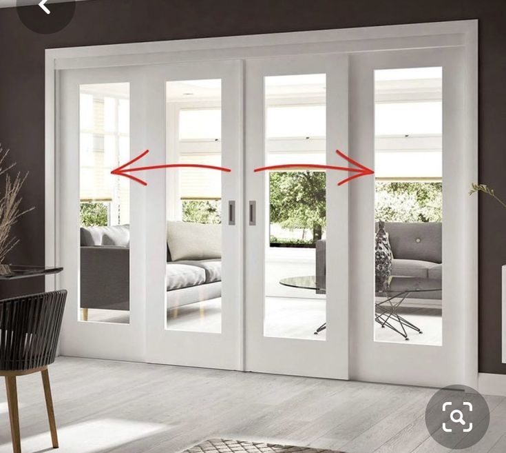 a living room with sliding glass doors and an area rug in front of the door