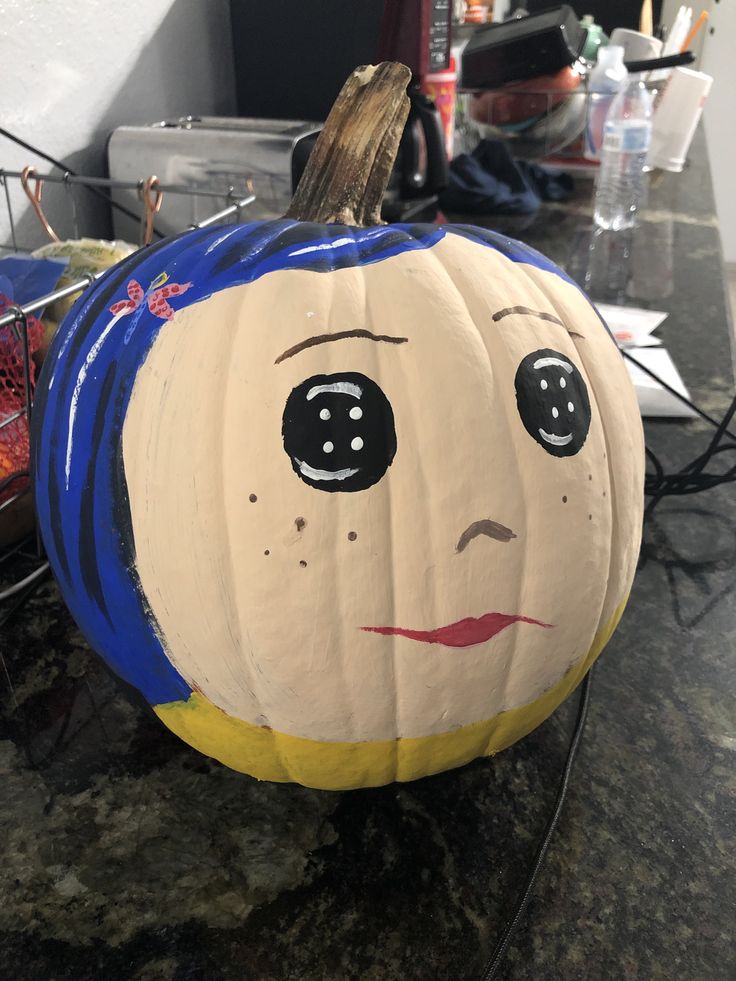 a pumpkin with a face painted on it