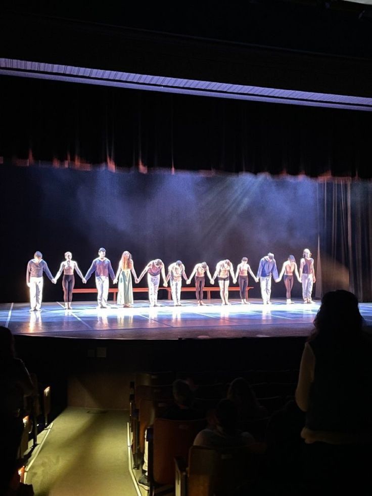 a group of people standing on top of a stage