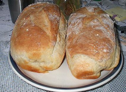 two loaves of bread sit on a plate