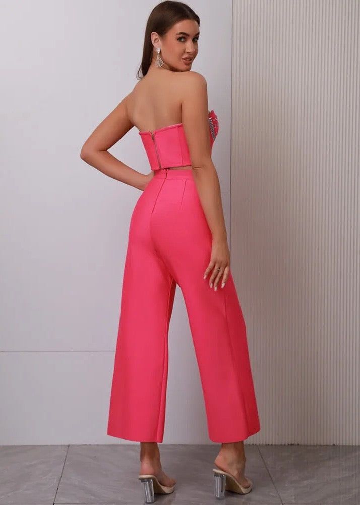 Add some sparkle to your party outfit with our Rhinestone Decor Bustier Top & Hollow Out Pants. Made with a hot pink bandage top and flared pants, this two-piece set is sure to turn heads. The rhinestone embellishments add a touch of glamour while the hollow out design adds a playful twist. Perfect for any celebration. Fabric: Slight Stretch Material: Polyester, Elastane High Waist Embellished Pants For Party, Glamorous Pink Embellished Bottoms, Glamorous Embellished Pink Bottoms, High Waist Pink Evening Bottoms, Pink High Waist Bottoms For Evening, High Waist Pink Bottoms For Evening, Summer Evening Bottoms With Rhinestones, Rhinestone Bottoms For Evening And Summer, Summer Evening Rhinestone Bottoms