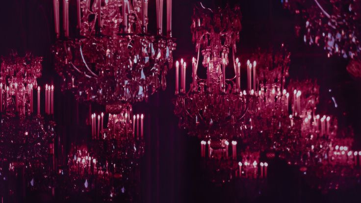 a large chandelier hanging from the ceiling in a room with many lights on it