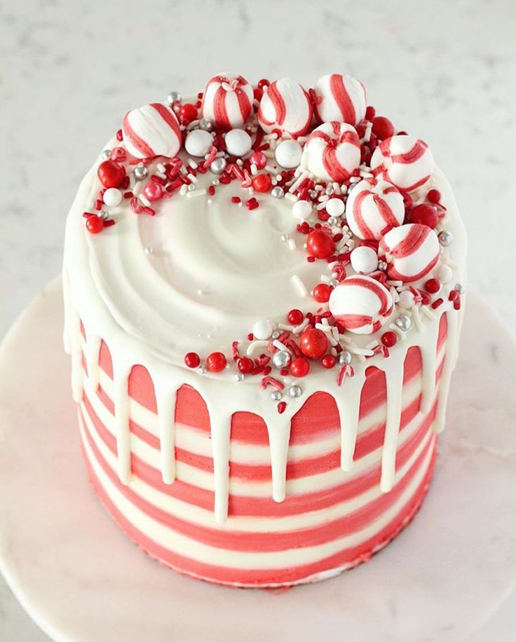 a red and white cake with candy canes on top