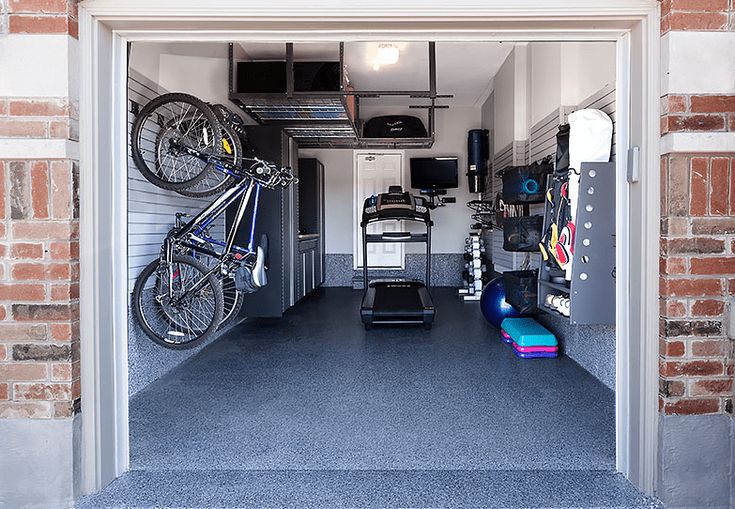 an open garage with two bikes and luggage