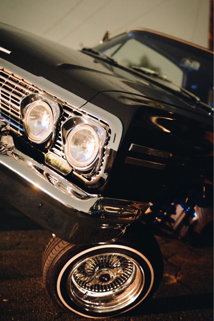 the front end of an old black car