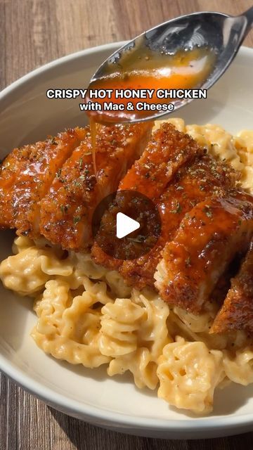 a white plate topped with pasta and meat covered in sauce