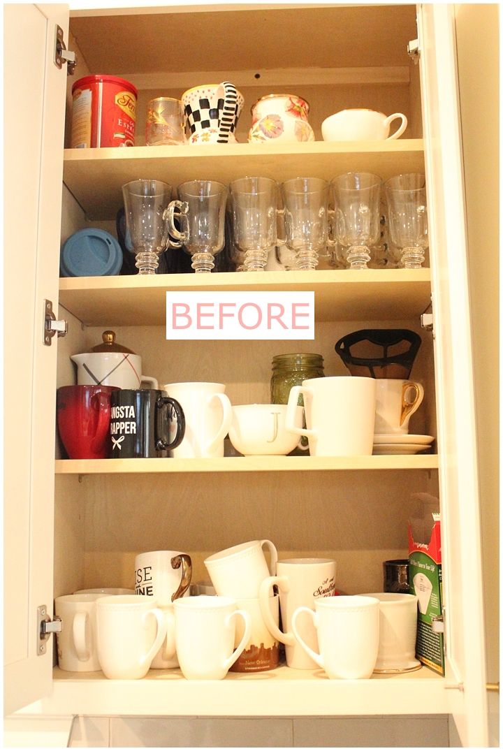 an open cabinet filled with cups and mugs