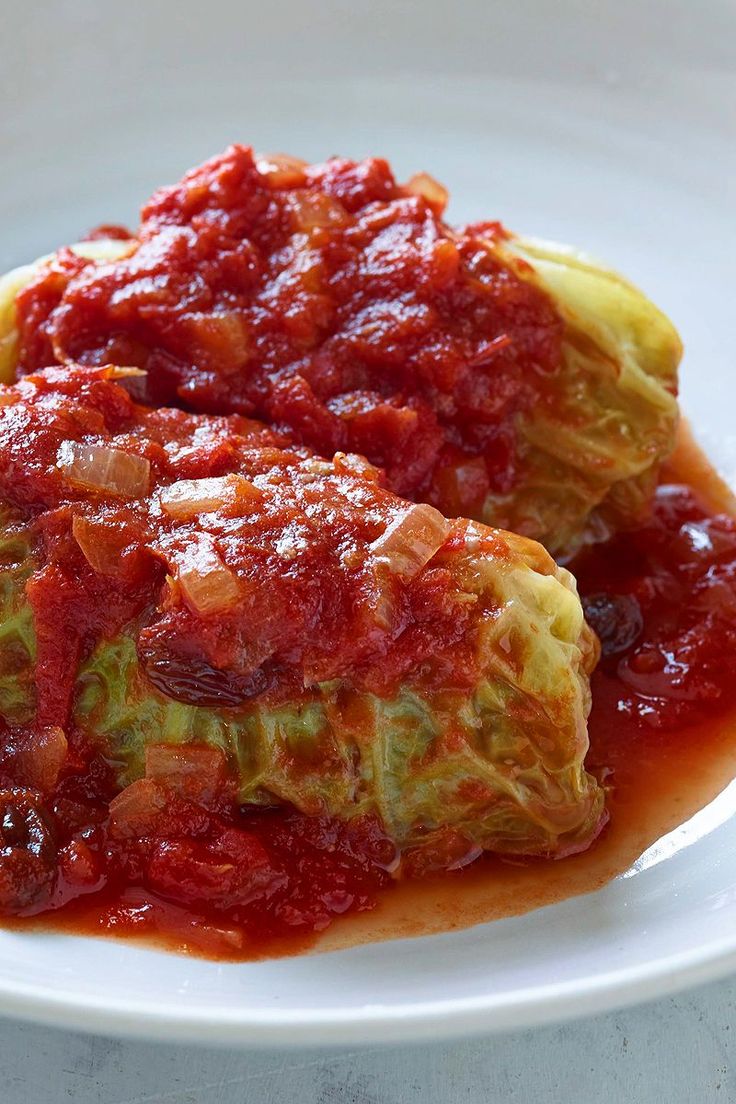 cabbage covered in sauce on a white plate