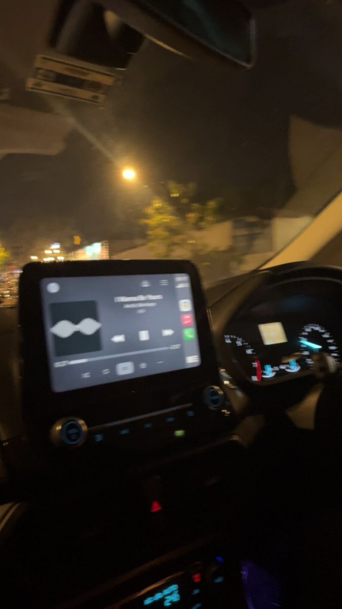 the dashboard of a car at night time