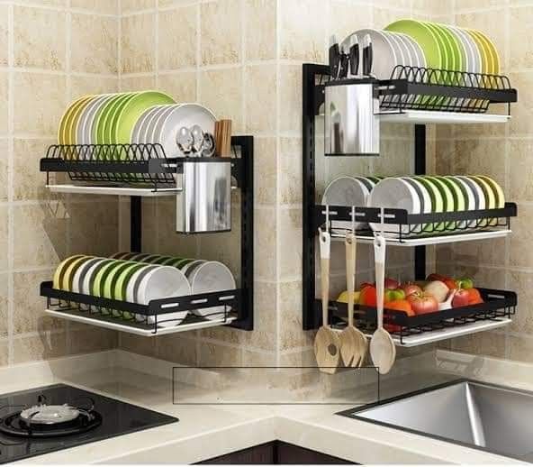 two black racks holding dishes and utensils in a kitchen