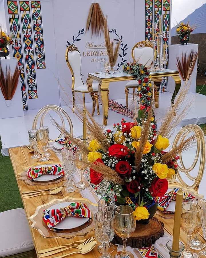 the table is set with flowers and plates