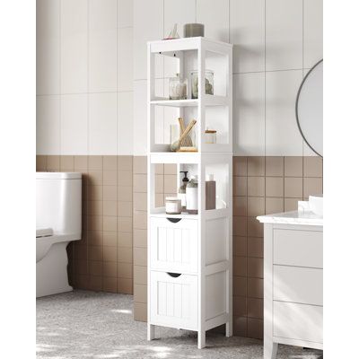 a bathroom with a toilet, sink and shelving unit