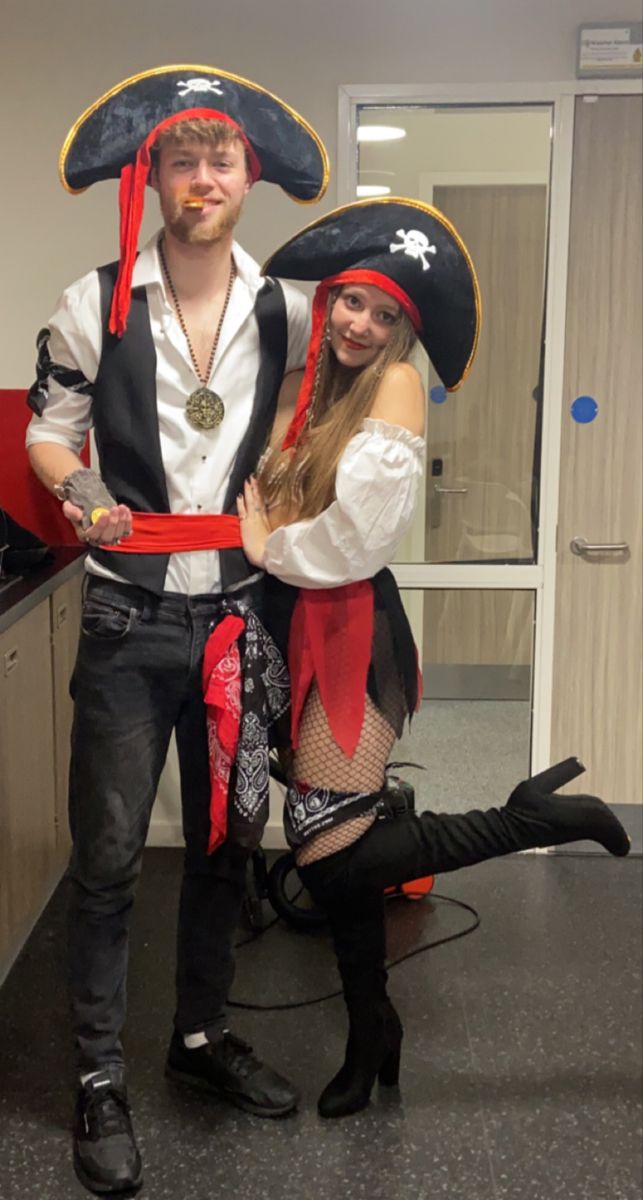 a man and woman dressed up in pirate costumes