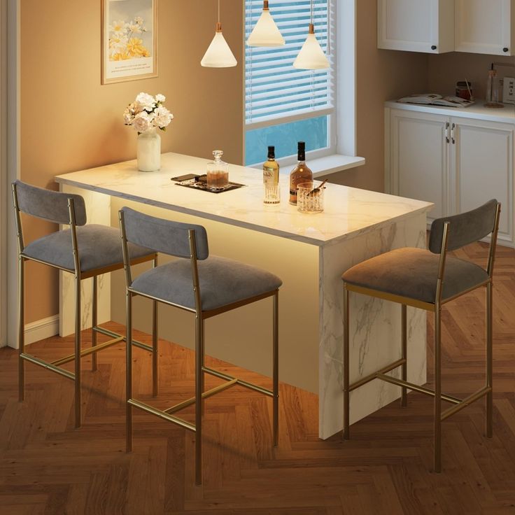 a kitchen island with three stools next to it