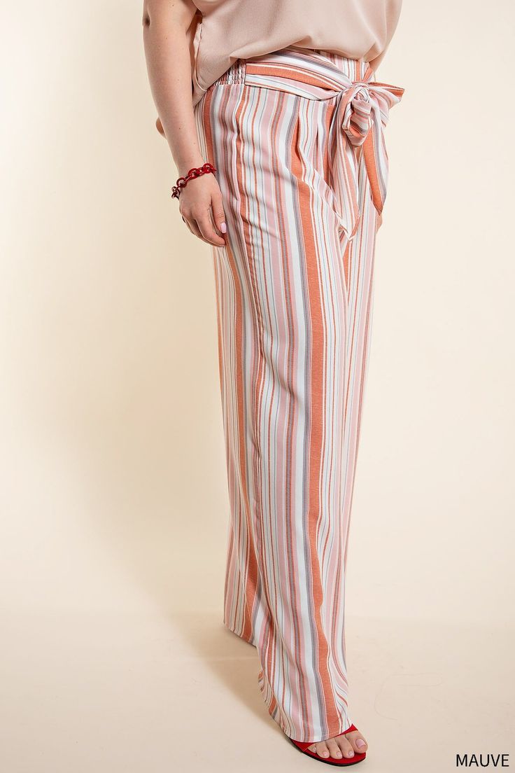 Workwear for the modern office — step up your 9 to 5 game with the One to Remember Tie Front Pants. These classic striped pants have been amped up with a smocked back and a tie front for a comfortable and stylish look. The mauve and white color combination makes them perfect for the Spring and Summer seasons, and the wide leg silhouette makes these long pants the perfect smart-casual choice. Get the perfect blend of comfort and style with the One to Remember Tie Front Pants. 100% Polyester Want Striped Wide Leg Trousers With Elastic Waistband, Striped Wide Leg Pants With Elastic Waistband For Work, Striped Wide Leg Ankle-length Pants With Elastic Waistband, Striped Wide-leg Pants With Elastic Waistband, Chic Striped Pants With Elastic Waistband, Spring Pinstripe Bottoms With Elastic Waistband, Striped Trousers With Elastic Waistband, Striped Straight Pants With Elastic Waistband, Straight Striped Pants With Elastic Waistband