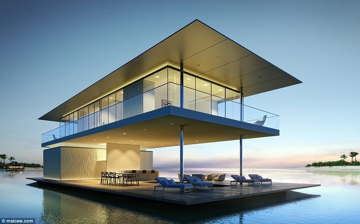 a modern house on the water at dusk