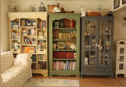 a living room filled with lots of furniture and bookshelves next to each other