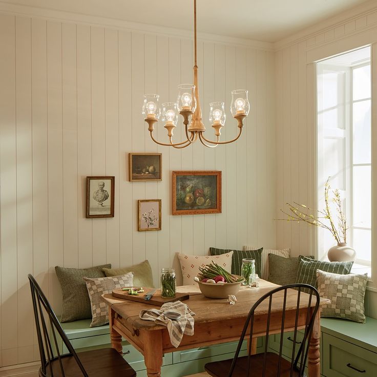 a dining room table with chairs and a bench