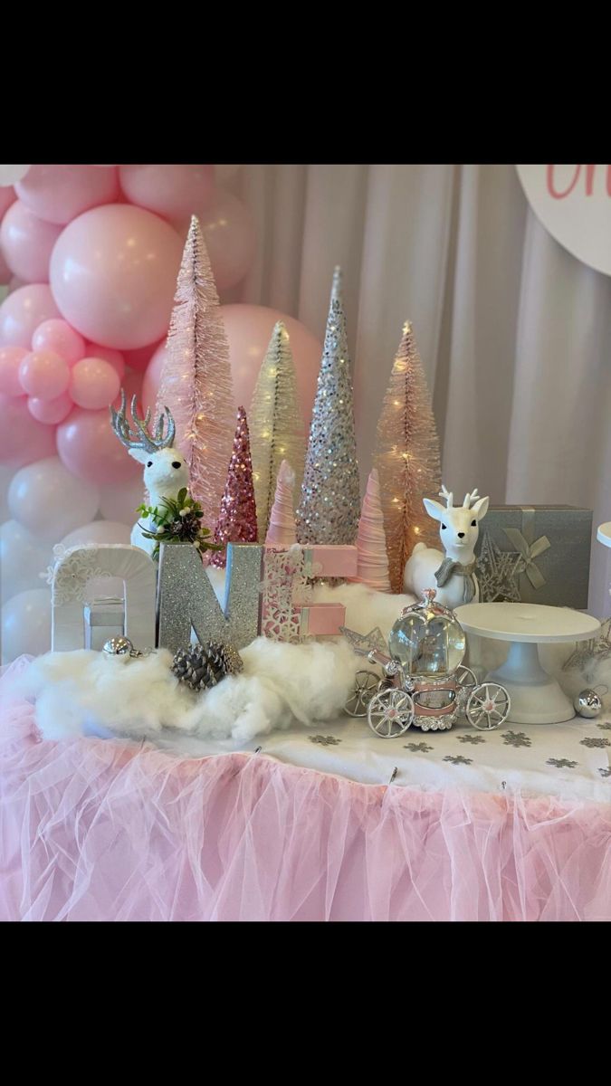 a table topped with lots of pink and silver decorations