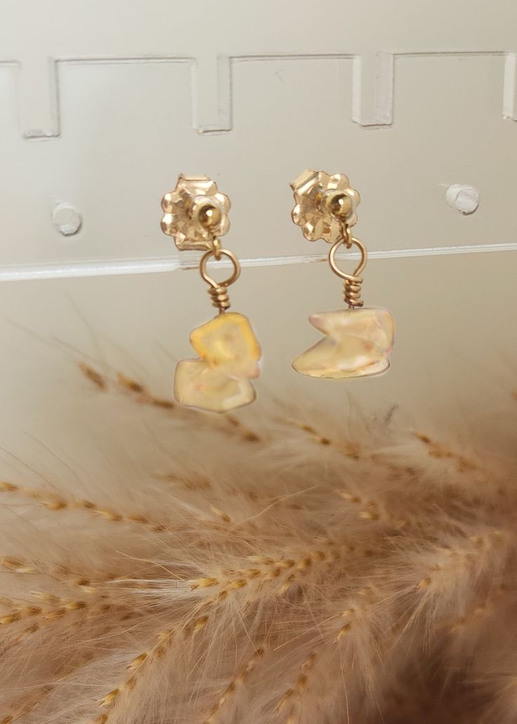 Our new faves! These 14K gold-filled wire gemstone earrings are handmade in our studio. Each earring includes a small bead with 2 gemstones hanging from it. Details-handmade in Brownsburg, Indiana -14K yellow gold-filled wire and components -colorful raw gemstone chips -gemstones approx. 3-7mm in size 14k Yellow Gold Filled Dangle Pearl Earrings, 14k Gold-filled Wrap Earrings With Ear Wire, Gold Briolette Single Earring, Handmade Delicate Yellow Gold Pearl Earrings, Delicate Handmade Yellow Gold Pearl Earrings, Dainty Handmade Gold Pearl Earrings, Nickel-free Gold Briolette Earrings, Gold Briolette Earrings Nickel Free, Handmade Briolette Yellow Gold Earrings