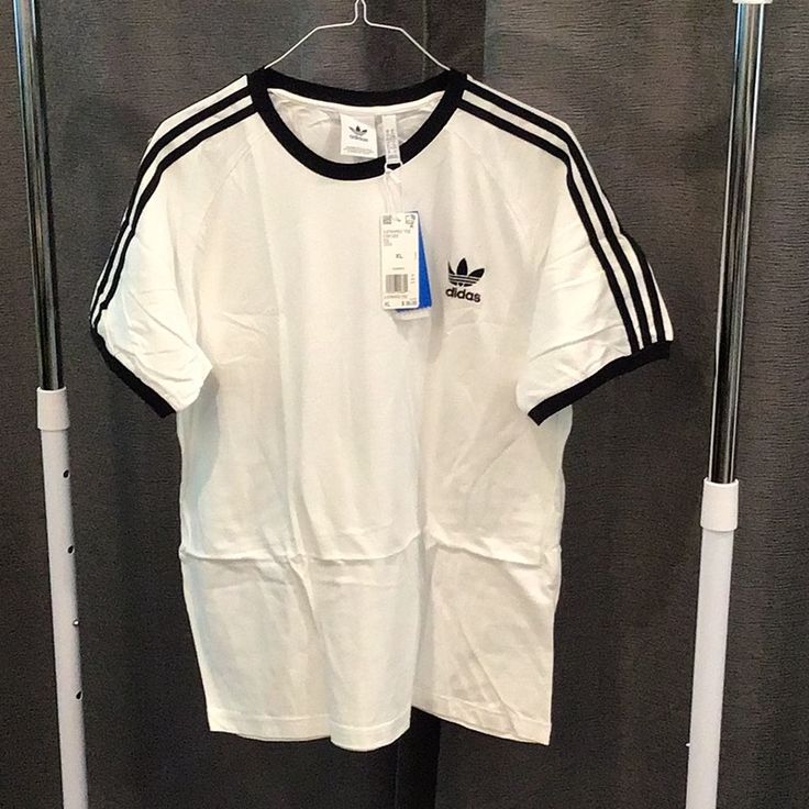 Mens Adidas T-Shirt Three Strip Nwt White With Black Strips And Logo Size Xl Basic Crew Neck T-shirt With Three Stripes, Adidas Cotton T-shirt For Streetwear, Adidas White Sporty T-shirt, White Adidas Sporty T-shirt, Adidas Cotton T-shirt With Three Stripes, Adidas Cotton Short Sleeve T-shirt, Basic Crew Neck T-shirt With Three Stripes Branding, Basic Three Stripes Crew Neck T-shirt, Adidas Basic T-shirt With Three Stripes