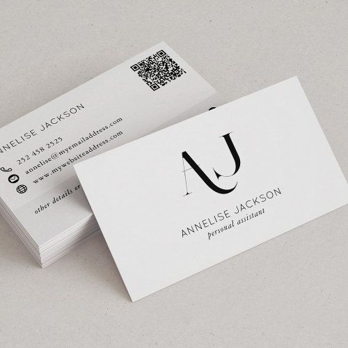 two business cards sitting on top of each other with q in the middle and q at the bottom