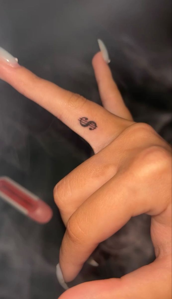 Dollar tattoo,tattoo,finger tattoo Money Sight Tattoo, Dollar Sign Tattoo On Finger, Money Sign Tattoo On Finger, Red Dollar Sign Tattoo, Dollar Sign Finger Tattoo, Coin Size Tattoo, Small Hand Tats For Women, Tattoos To Hide From Parents, Hot Small Tattoos