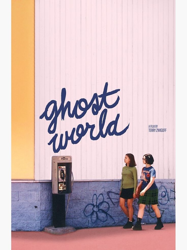 two girls standing in front of a wall with graffiti on it that says ghost world