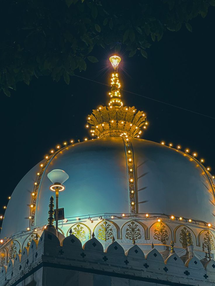 an ornate dome with lights on it at night