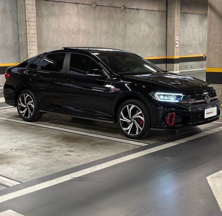 a black car parked in a parking garage