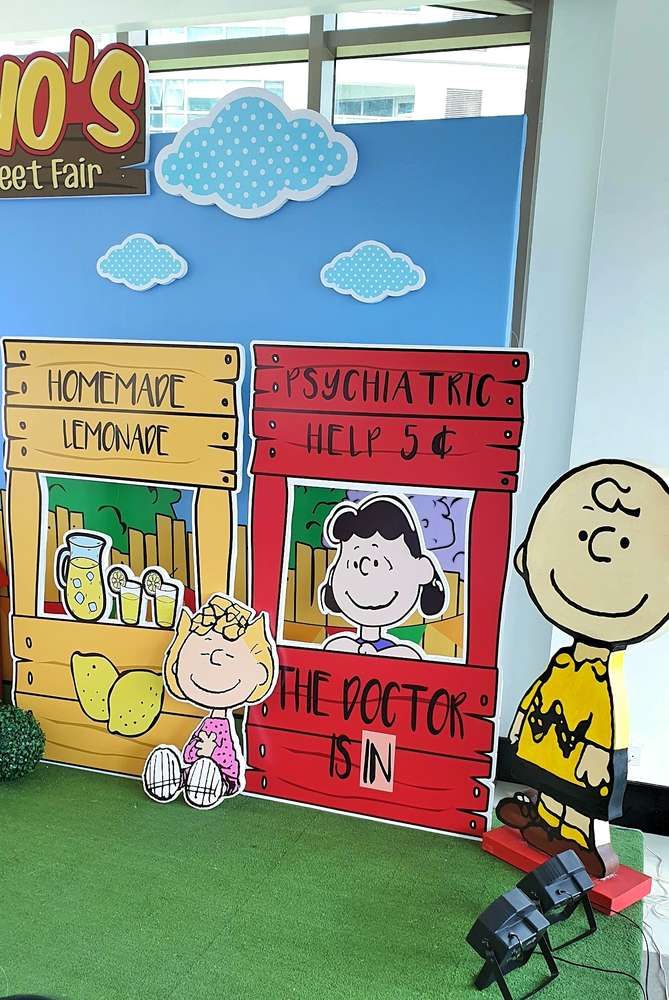 there is a display in the room with peanuts and charlie brown on it's side