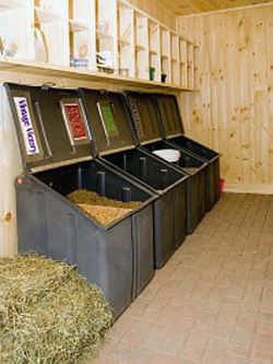 the inside of a storage room with several bins full of dirt and hay in it