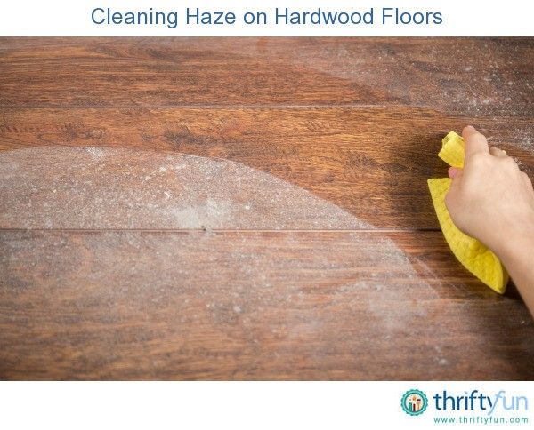 a person cleaning a wooden floor with a yellow cloth