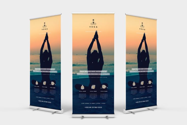 two roll up banners with the image of a woman doing yoga in front of an ocean