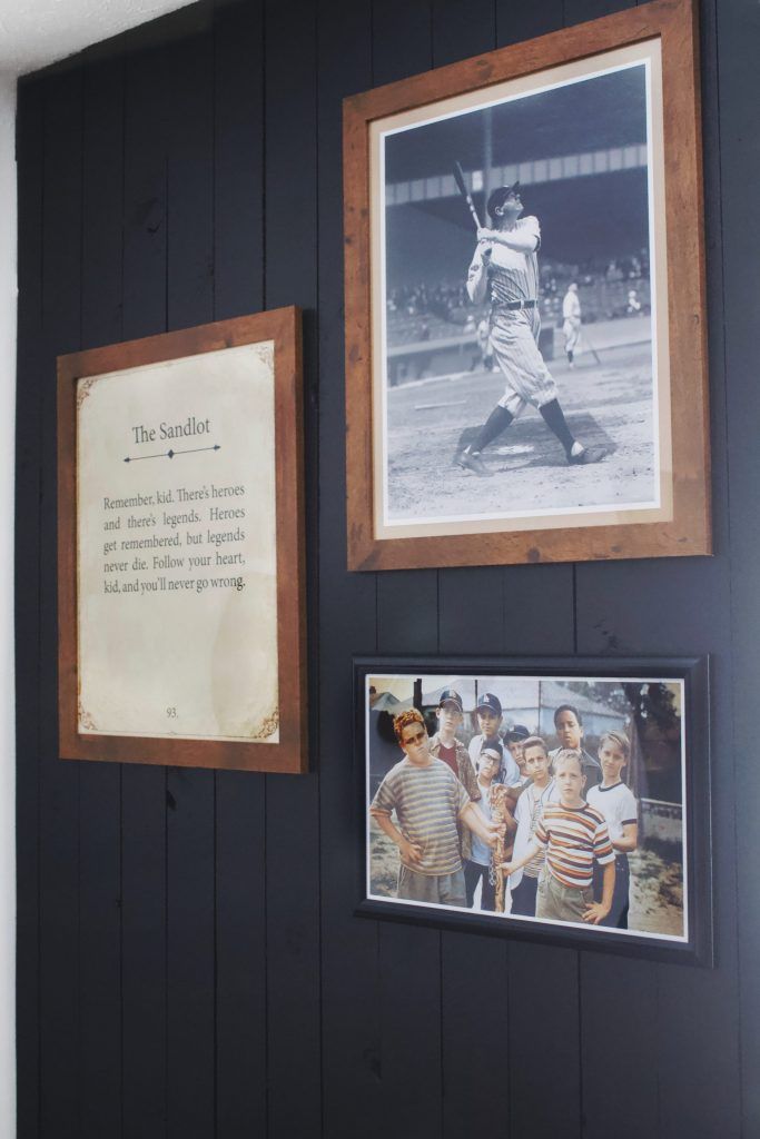 baseball memorabilia is displayed on the wall next to framed photos and pictures with an inscription