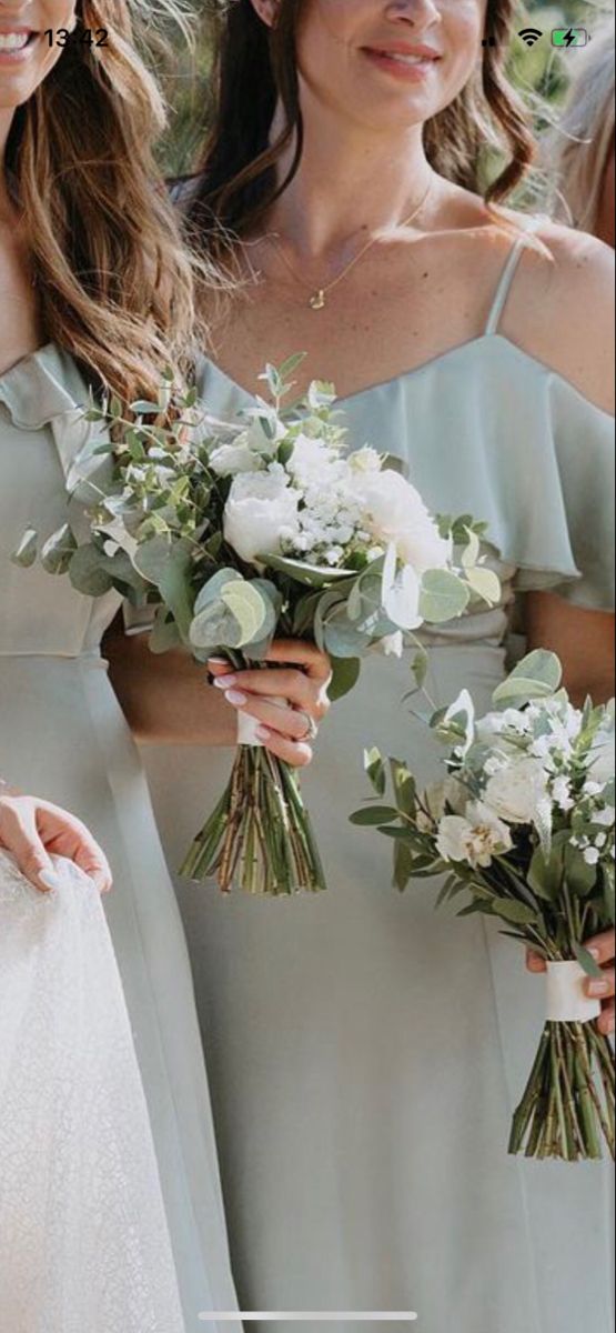 the bridesmaids are holding their bouquets together