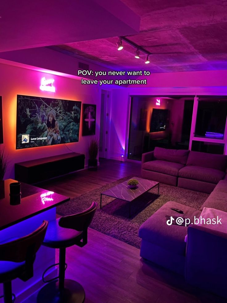 a living room filled with furniture and purple lighting