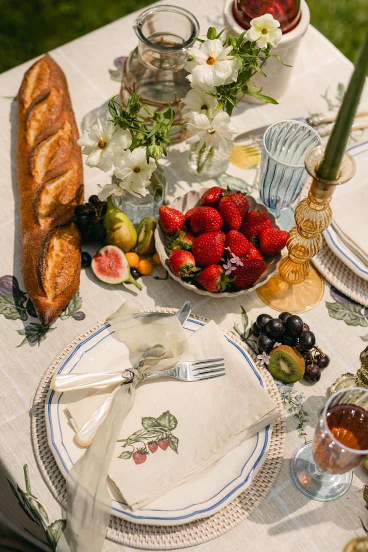 the table is set with fruit and bread