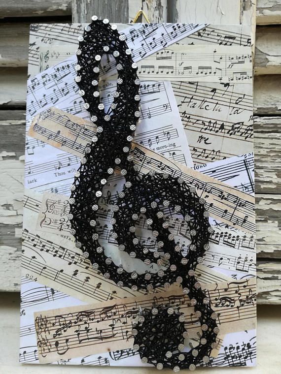 an art piece made out of sheet music and beads on top of musical notes,