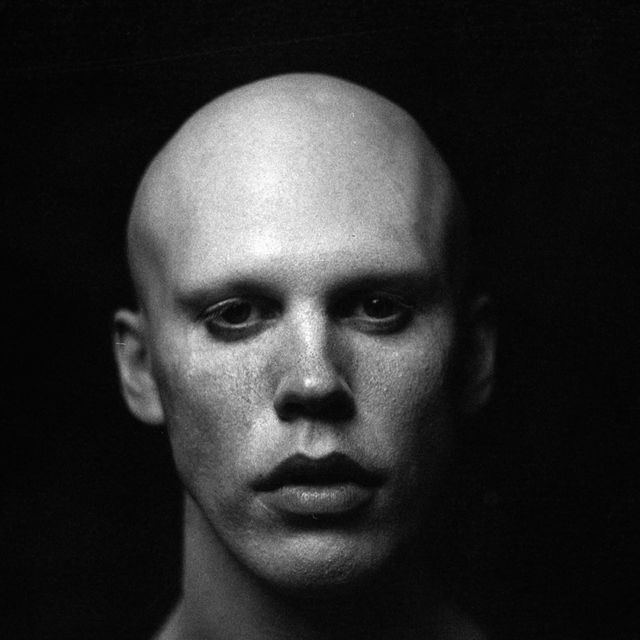 black and white photograph of man with bald head