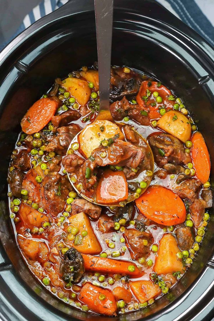 a crock pot filled with meat and vegetables