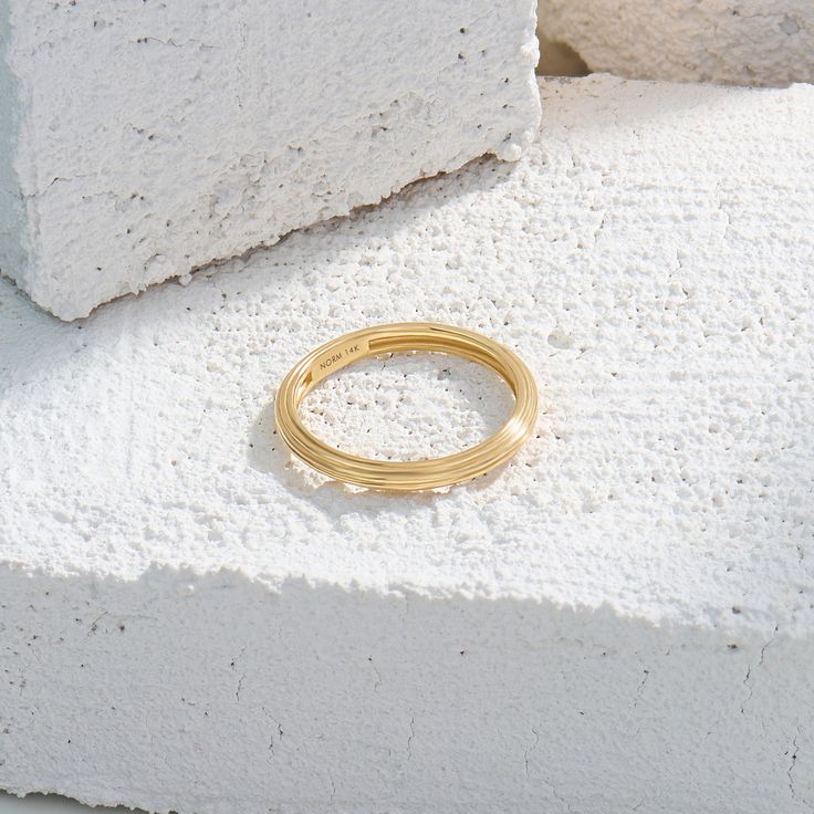 Discover the beauty of simplicity with our Linear Band Ring. This exquisite ring features sleek and straight-lines for a clean and aesthetic look. Whether you choose to wear it as a standalone piece for minimalist elegance or stack it with other rings to create a personalized look, the Linear Band Ring is a versatile and chic addition to your collection that will elevate your style to new heights. - Made in 14k solid gold - Band Width: 2.39 mm / 0.09 inches - Thickness: 1.69 mm / 0.07 inches - T Formal Stackable Rings With Smooth Bezel, Timeless Polished Stackable Rings, Everyday Timeless Stackable Rings With Polished Finish, Timeless Stackable Round Rings, Everyday Timeless Stackable Rings With Smooth Bezel, Everyday Stackable Rings With Smooth Bezel, Minimalist Ring With Smooth Bezel And Thick Band, Modern Everyday Stackable Rings With Round Band, Modern Everyday Stackable Rings With Open Band