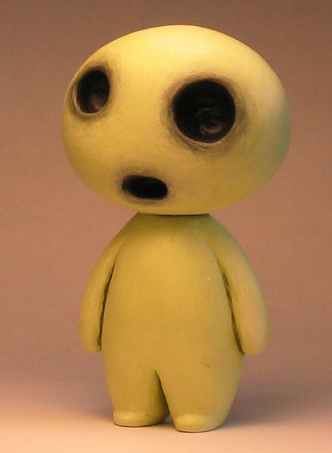 a small yellow toy with big eyes