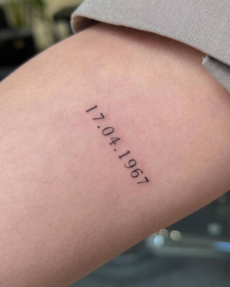 a woman's arm with the word today tattooed on it