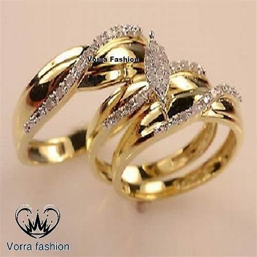 two gold wedding rings with diamonds on them