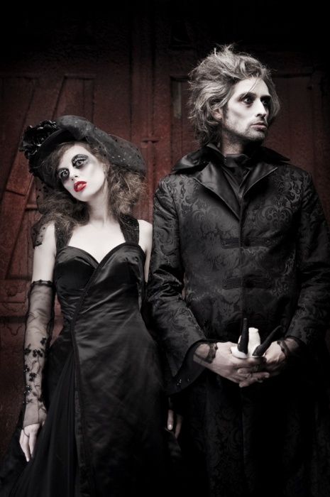 a man and woman dressed up in gothic costumes